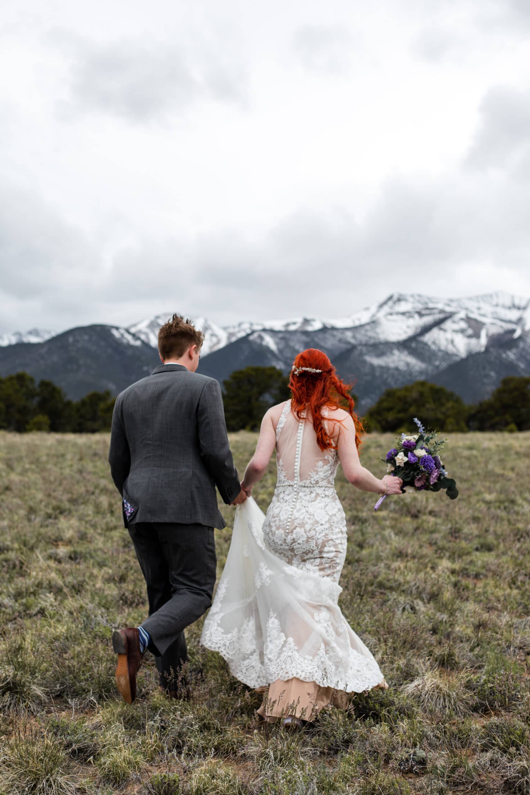 elopement couple running in colorado mountains